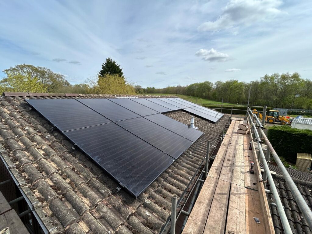 Neater Heat solar installation showcasing sleek solar panels mounted on a residential roof, surrounded by a clear blue sky. The installation reflects the company’s commitment to neat and tidy workmanship, emphasizing clean lines and professional quality.